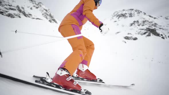Female Skier Skiing One Turn in Slow Motion on Ski Piste