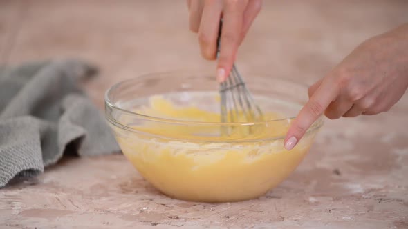 Stirring Dough for Eclairs into Glass Bowl