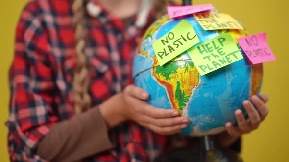 Closeup Earth Globe with Adhesive Notes Expressing Ecological Issues in Hands of Unrecognizable alt