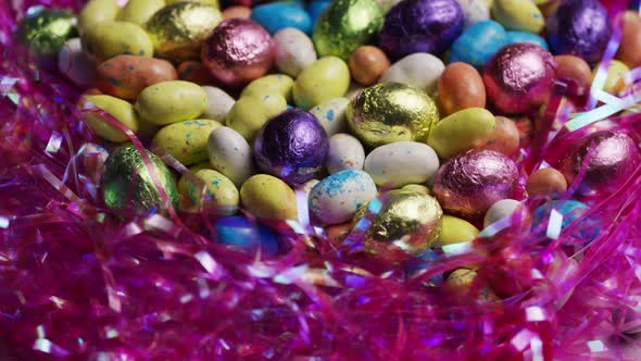 Rotating shot of colorful Easter candies on a bed of easter grass  alt
