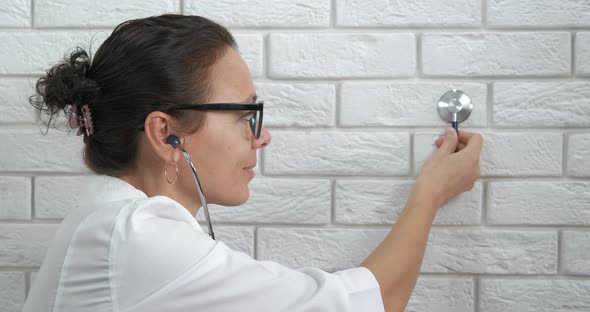 Cute doctor by wall. alt