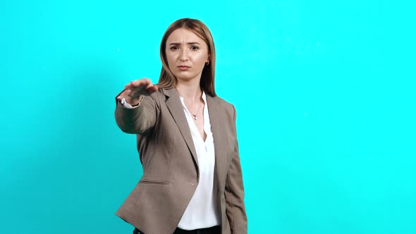 The Happy Young Woman Shows a Gesture with Her Hand To Say That She Feels Good. alt