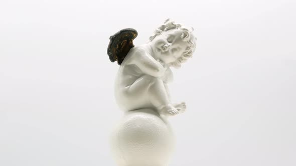 Beautiful Little Angel Statuette on a White Background 