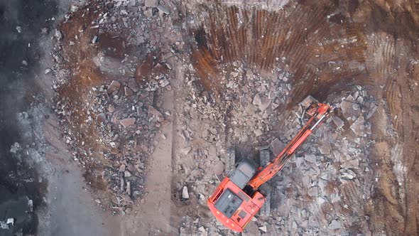 View From Above. A Large Excavator Dismantles the Concrete Base alt