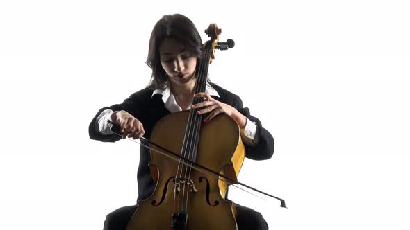 Musician Girl Plays a Violoncello Rehearsing a Composition. White Background alt