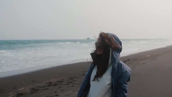 Beautiful Girl Enjoying the Wet Wind on the Beach alt