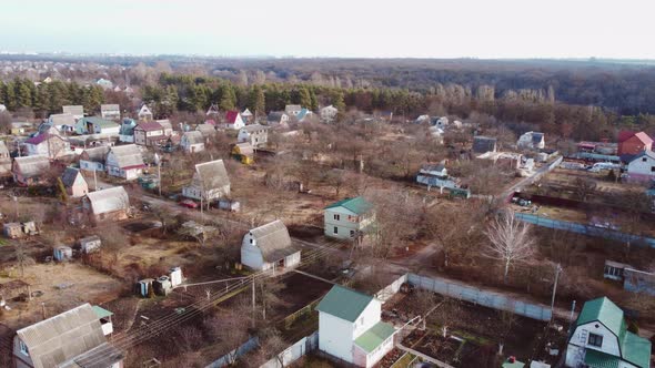 Aerial Drone View Flight Over Small Brick Houses with Plot of Land in the Middle alt