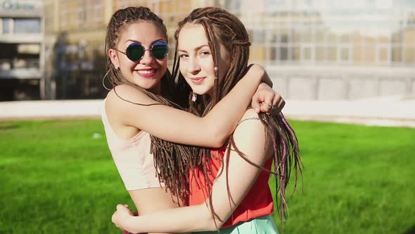 Two Happy Young Girls with Dreads Hugging Each Other alt