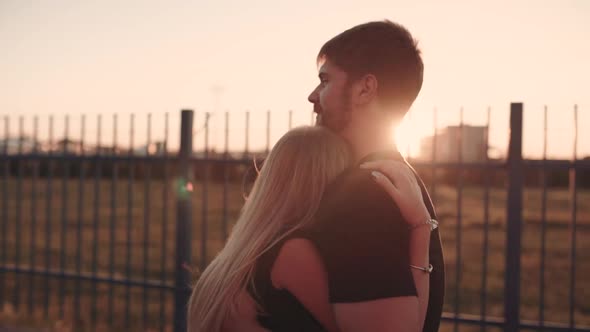 An Attractive Couple in Love Embrace and Enjoy an Intimate Moment Together Against the Sunset or alt