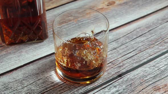 Ice Cube Falls into a Highball of Whiskey