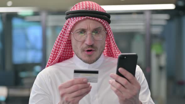 Middle Aged Arab Man with Unsuccessful Online Shopping on Smartphone alt