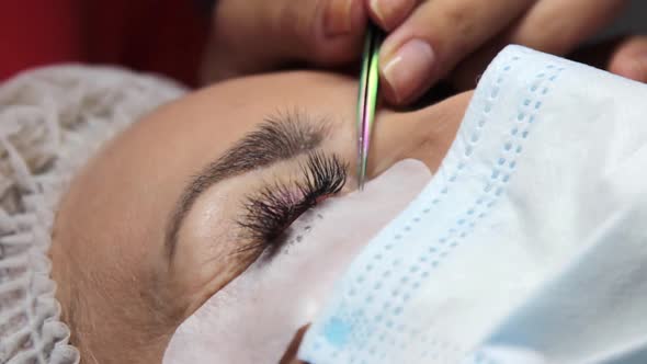 the Master Gently Pours Special Eyelash Glue Into a Saucer That Will Be Used in Work with the Client