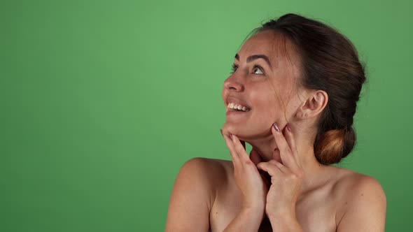 Attractive Woman Looking Surprised on Green Chromakey Background alt