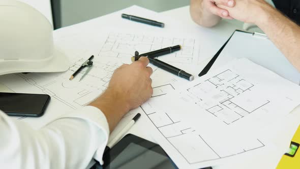 Engineers Team Discussing on the Drawing Table for Planning the Work in the Project and Real Estate alt