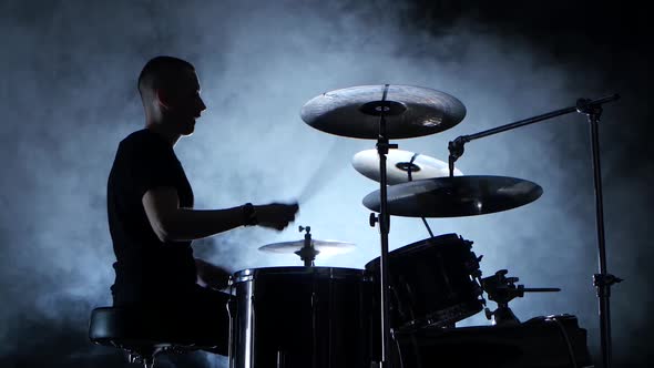 Energetic Musician Plays Good Music on Drums. Black Smoky Background alt