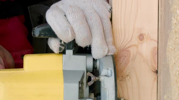 Vertical Shot Csucasian Carpenter Processes Wood Beam with Milling Machine