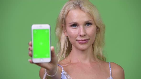 Young Happy Beautiful Businesswoman Showing Phone