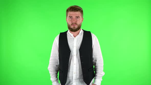 Confident Man Smiling While Looking at Camera. Green Screen alt