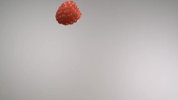 A flying red raspberry passing through in front of the camera