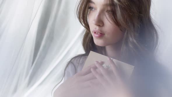 Woman Opening Envelope in Morning alt