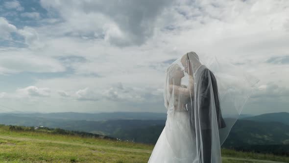 Groom with Bride Having Fun on a Mountain Hills. Wedding Couple. Happy Family alt