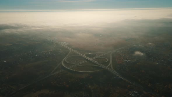 Roundabout With Traffic. Autumn Fog