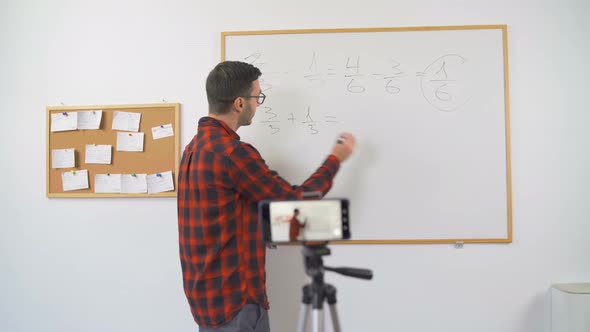 Teacher Explaining Mathematics on E-learning Platform Online alt