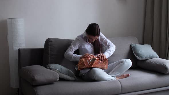 Girl at Home Fiddling with Gifts alt
