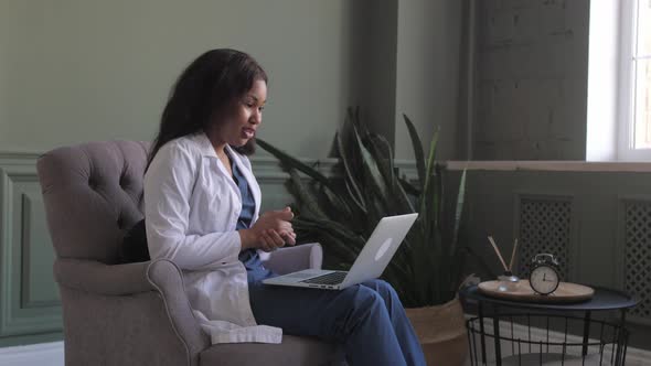 African American Doctor Woman Conducts Videoconference with Patient alt