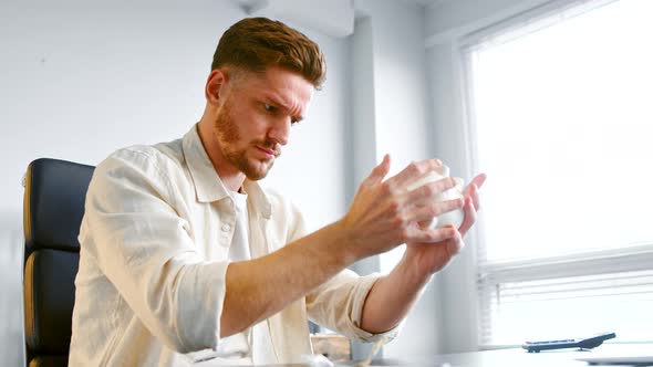 Concentrated financial company manager holds white piggy bank alt