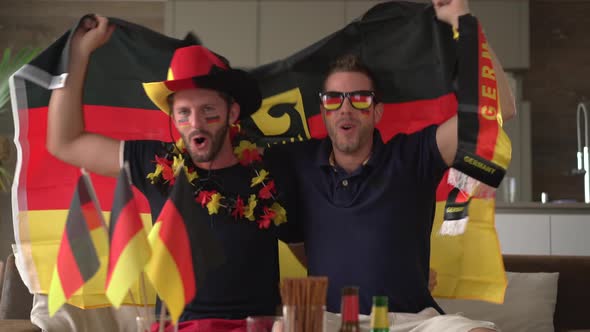 Two German Fans Cheering at Home for Germany