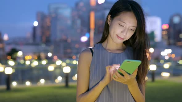 Woman reading on smart phone at outdoor alt
