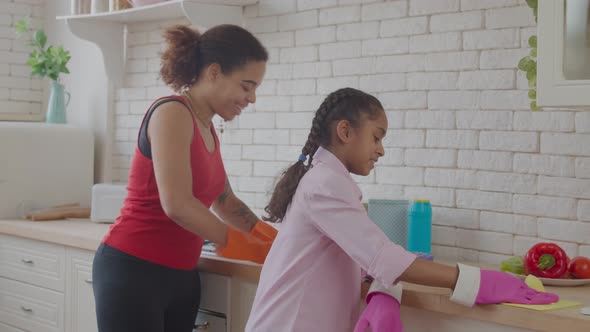 Positive Mom and Little Child Cleaning Countertop alt