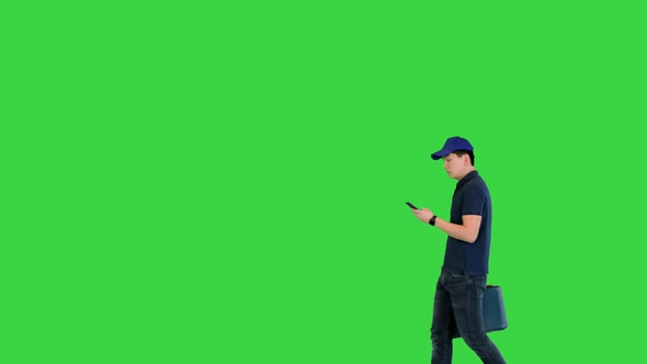 Worker with a Toolbox Arrives at Client's Home Using Mobile Map on a Green Screen Chroma Key alt