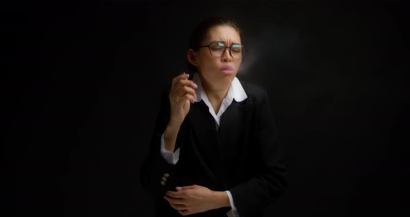Business Woman Experiences Coughing From Hovering on Isolated Black Background