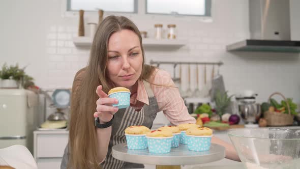 Woman smelling cupcakes in the kitchen