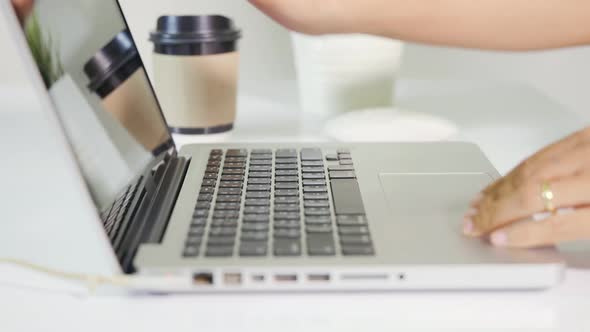 Close up Hands of business woman over laptop keypad during working at desk alt