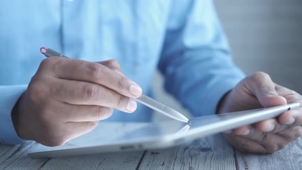 Holding Digital Tablet and Graphic on Table alt