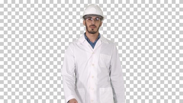 Young Engineer in Robe and Helmet Putting Glasses on While Walking alt