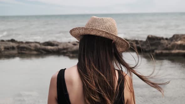 Close Shot Of A Woman Looking At A Puddle alt