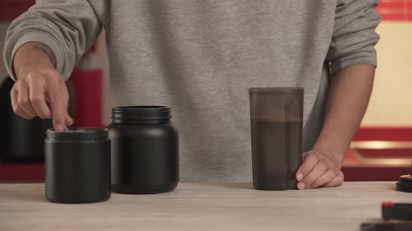Serving A Portion Of Protein Powder and creatine Into The Shaker bottle alt