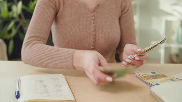 Housewife Counting Money for Monthly Expenses Rich Woman Holding a Stack of Euro in Hands alt