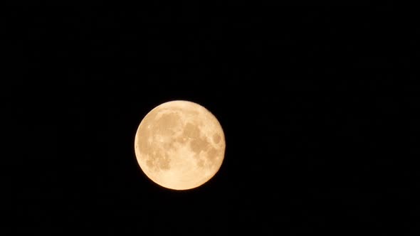 Full moon moving quickly across the sky, time-lapse shot at night