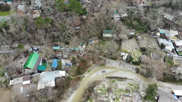 Flying over the forest. Flying over a mountain village. Caucasus mountains. alt