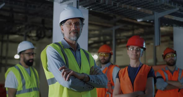 Confident Mature Foreman Near Female Colleague alt