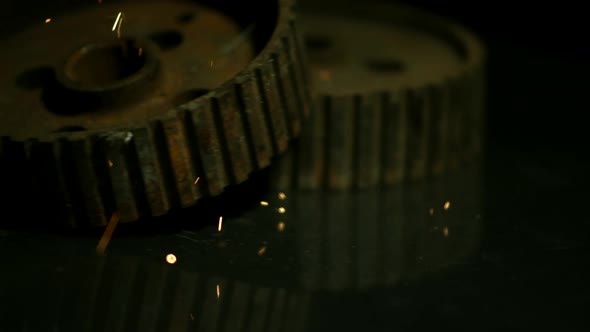 Sparks with gears in ultra slow motion 1500fps on a reflective surface - SPARKS w GEARS 021 alt