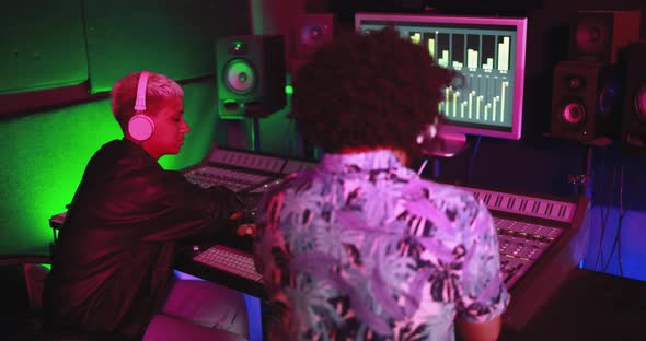 Musician and sound engineer - People mixing new album inside boutique recording studio alt