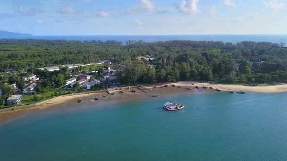 Aerial view of beach with waves rolling into the shore, Phuket bay island, Thailand. alt