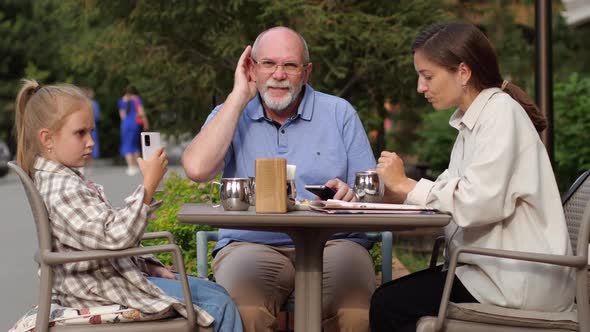 Family in a Street Cafe