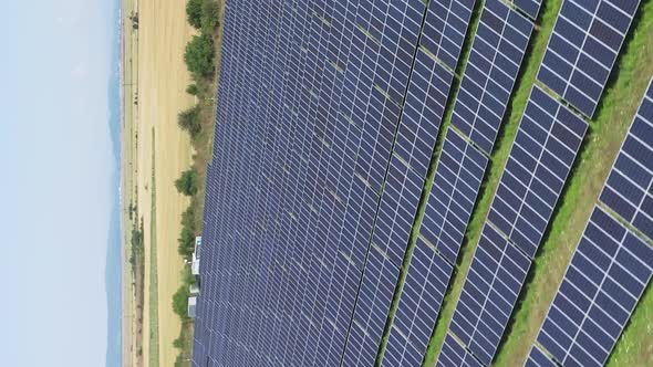 Vertical Shot Of Vast Solar Power Station With Solar Panel Cells On Fields On Countryside. - Trackin alt